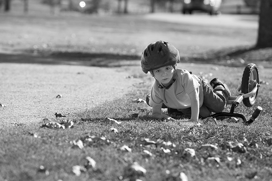 boy falling over on a bike