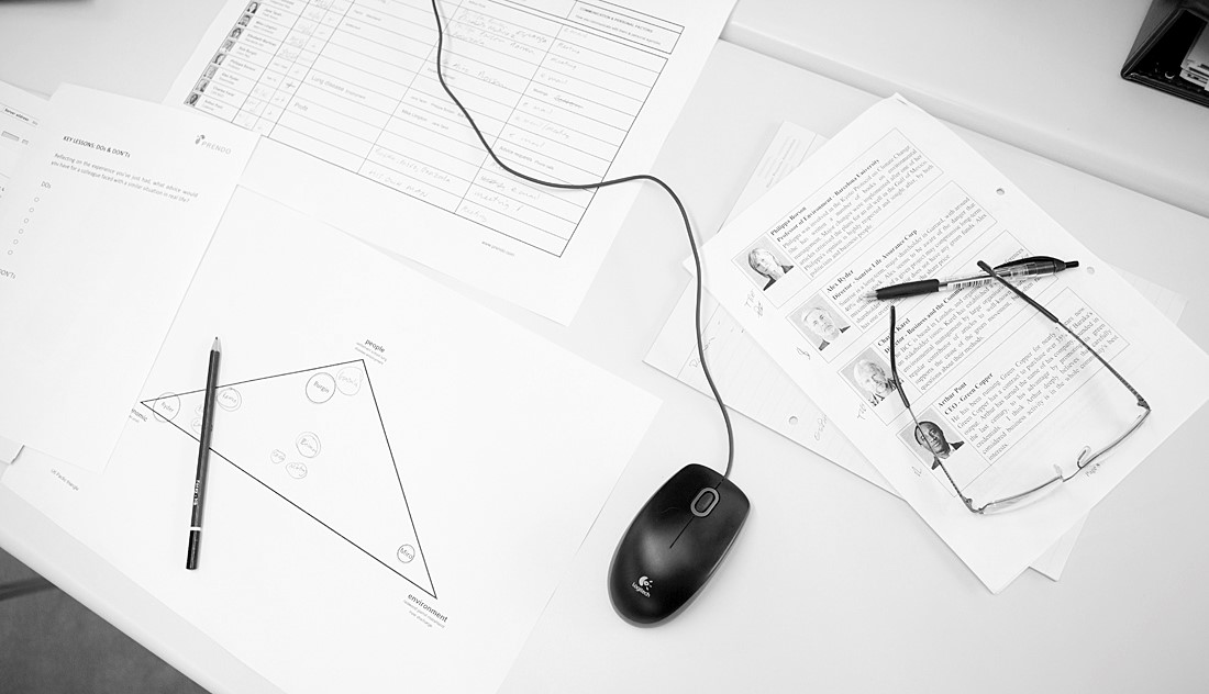 computer mouse surrounded by papers