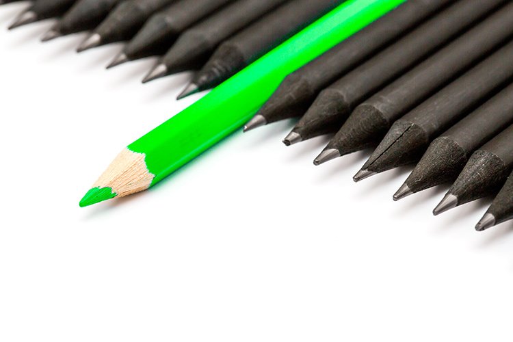 green pencil sticking out from black pencils